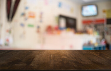 Empty dark wooden table in front of abstract blurred bokeh background of restaurant . can be used for display or montage your products.Mock up for space.
