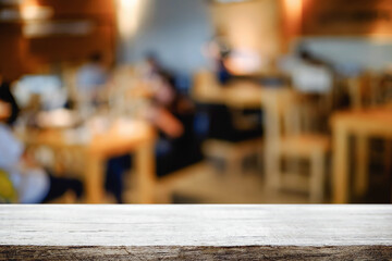 Empty wooden table space platform and blurred resturant or coffee shop background for product display montage.