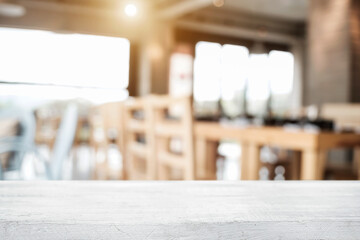 Empty wooden desk space platform with blur restaurant or coffee shop background for product display montage.