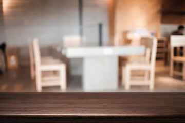 Empty wooden table space platform and blurred resturant or coffee shop background for product display montage.