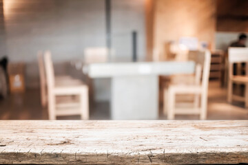 Empty wooden table space platform and blurred resturant or coffee shop background for product display montage.