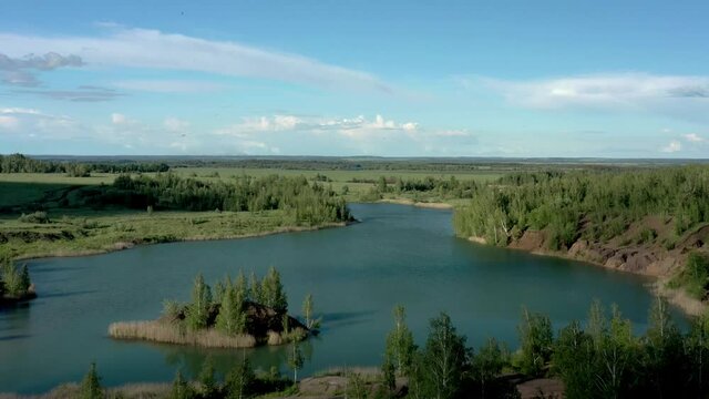 Tula oblast romantsevo hills and lakes drone aerial shot. High quality 4k footage fly over tulskaya oblast romantsevskie hills, konduki shot under cloudy blue sky