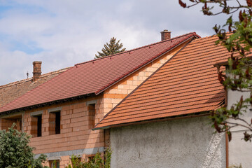 reconstruction and extension of an old house, orange brick construction and roof repair