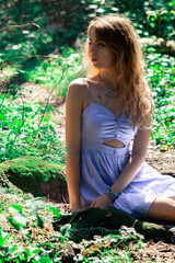 Fototapeta premium Photoshoot in the jungle. Girl in a blue dress. Photoshoot in Bali.