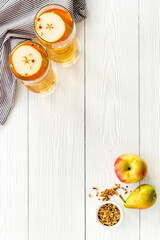 Fruit drinks with apple and pear on white wooden desk from above copy space