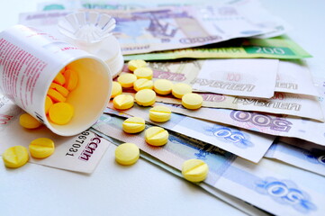 Composition consisting of money and pills. Money. Tablets. Medication.