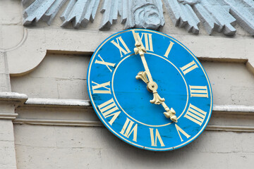 Antique blue clock with golden Roman numerals