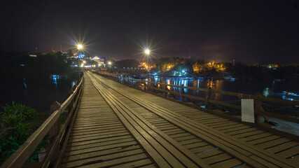 Fototapeta na wymiar Wooded bridge over the river in Sangkhlaburi District, Kanchanaburi, Thailand