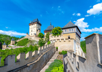 Fototapeta na wymiar View of the famous Karlstejn castle, Czech republic. Castle built in gothic style by king and emperor of Roman rise, Charles IV. Czech historic heritage, beautiful summer day.