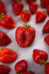 Strawberries on the table top view. Red berries pattern. Strawberry crop. Food still life in the spotlight. Red berry background.