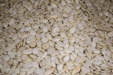 White dried pumpkin seeds. Natural background
