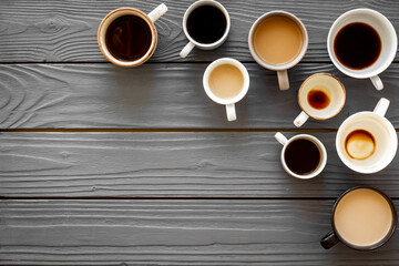 Many cups of coffee on wooden table top-down copy space