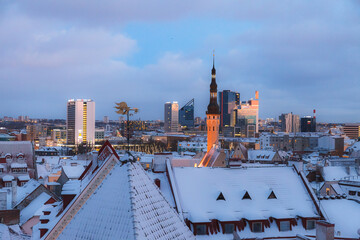 Fototapeta premium TALLINN, ESTONIA - DECEMBER 26, 2018: Roof and tower of old town. Winter panoramic aerial view by evening.
