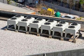 Equipment of air conditioner units on a roof of an industrial building. HVAC fan machines.