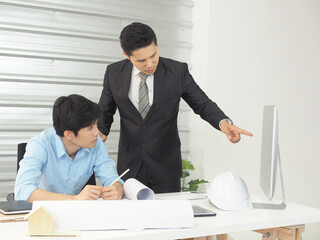 Asian businessman and architect or engineer are discussing work together in office.Man pointing at screen.
