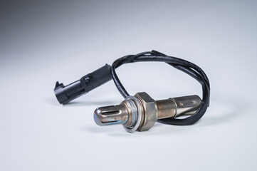 new on a grey gradient background sensor oxygen lambda probe the car's exhaust system