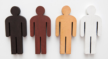 Four wooden figure persons with different color on the table