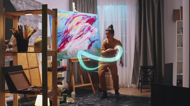 Female painter using mixed reality concept, drawing on virtual canvas in augmented reality. 3D speciall visual effect