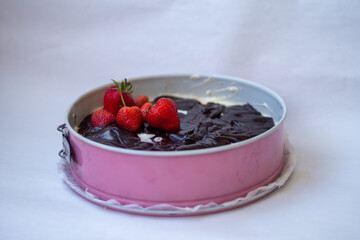 strawberry and chocolate on cake in pink form