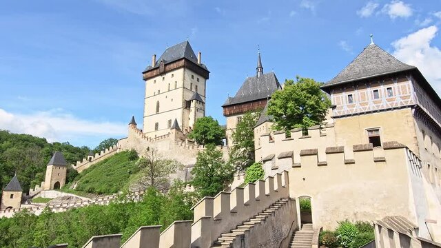 View of the famous Karlstejn castle, Czech republic. Castle built in gothic style by king and emperor of Roman rise, Charles IV. Czech historic heritage, beautiful summer day.