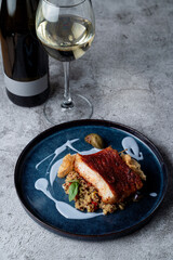 Fried cod with crispy golden crunch with a glass of expensive white wine, fashionable restaurant