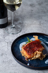 Fried cod with crispy golden crunch with a glass of expensive white wine, fashionable restaurant