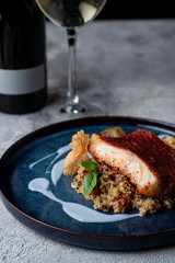 Close up of roasted fish with couscous and blueberry sauce, fine dining meal in a restaurant