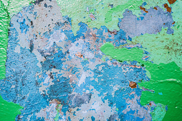 Old dirty painted wall. Several layers of peeling paint. blue green rusty. background texture. Horizontal