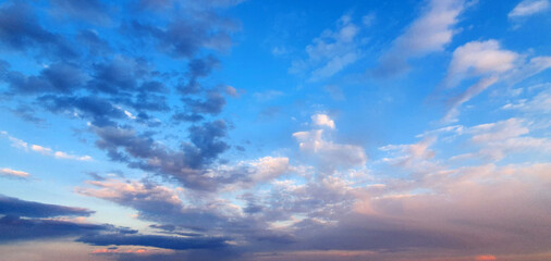 Naklejka na ściany i meble Colorful dramatic sky with big clouds and sunset
