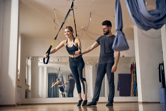 Pleased fit female doing a total body resistance exercise