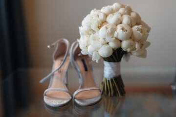 beautiful fresh wedding bouquet with bride's shoes