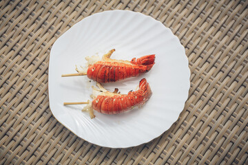 Grill lobsters on white plate