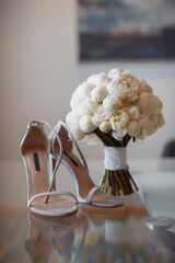 beautiful fresh wedding bouquet with bride's shoes