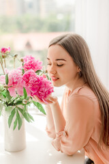 young woman with bouquet of peonies