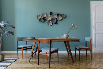 Modern and stylish dining room interior with glamour wooden table , elegant chairs and design...