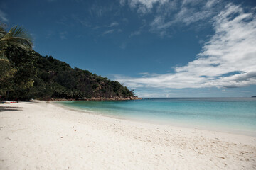 Beautiful seychelles island, ocean shore with white sand and blue sky