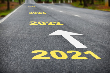 Number of 2021 to 2024 on asphalt road surface with marking lines, happy new year concept
