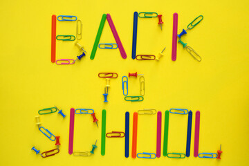 Back to school lettering made of colorful paper clips, buttons and counting sticks made of plastic...