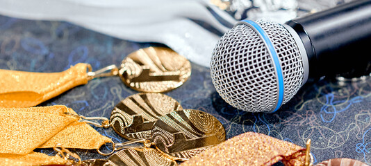 Awards, medals with ribbons on the table with a microphone 