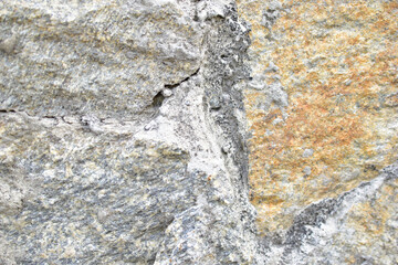 Gray blue old wall made of colored stones and cement
