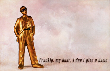Golden plaster man figure in classic suit, sunglasses and hands in pockets. Quote from the movie...