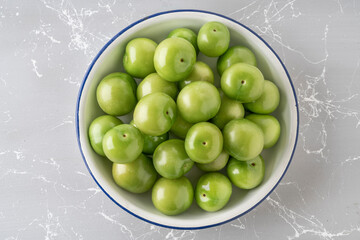 fresh and ripe green plums on a plate