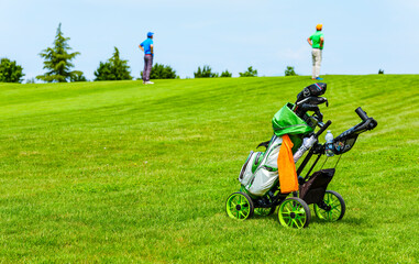 Golf cart with bag and golf clubs on a golf course.