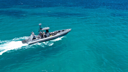 Aerial drone photo of luxury inflatable speed boat cruising in deep blue Aegean sea, Mykonos island, Cyclades, Greece