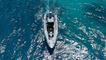 Aerial drone photo of luxury inflatable speed boat cruising in deep blue Aegean sea, Mykonos...