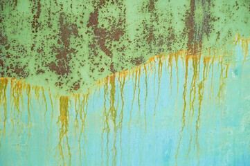 Texture, rust leaks on top of the paint. Metal surface, abstraction.