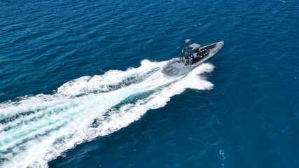 Aerial drone photo of luxury inflatable speed boat cruising in deep blue Aegean sea, Mykonos...
