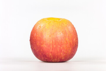 Yellow apple on a white background in isolation with water droplets on the skin