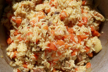 Cooked pilaf in cauldron on coals