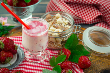 Sweet strawberry and healthy, wholesome food in composition on the table.